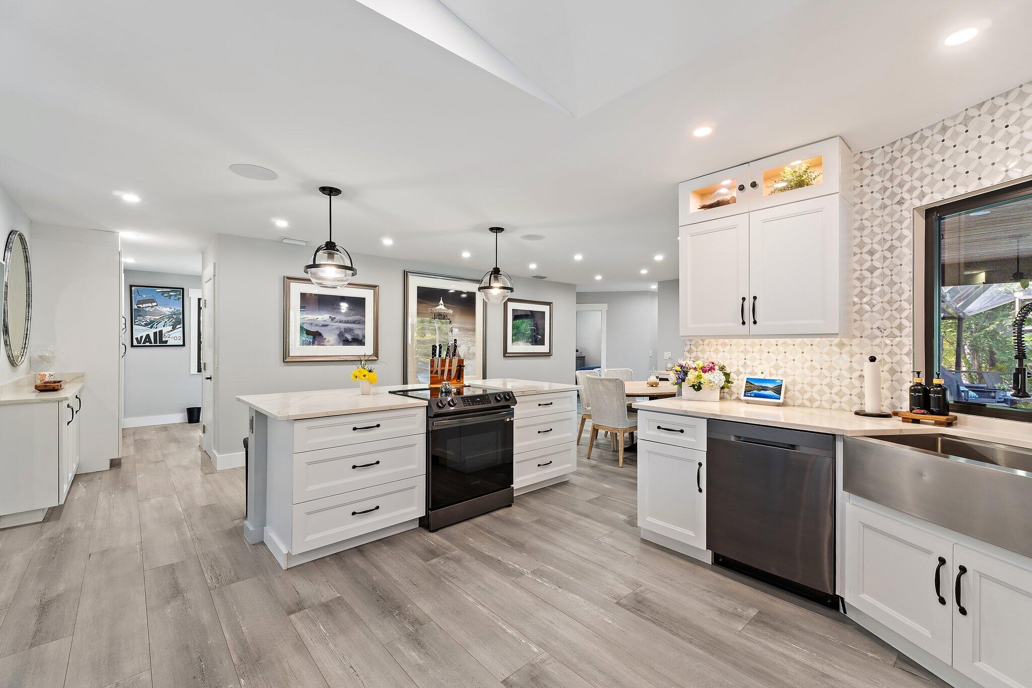 11845 165th Road North Jupiter, FL 33478 - Photo 26 of 68 a kitchen with stainless steel appliances kitchen island granite countertop a stove and a sink