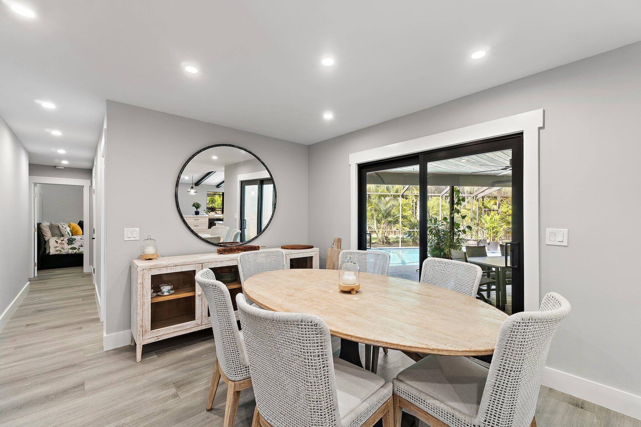 11845 165th Road North Jupiter, FL 33478 - Photo 30 of 68 a view of a dining room with furniture window and wooden floor