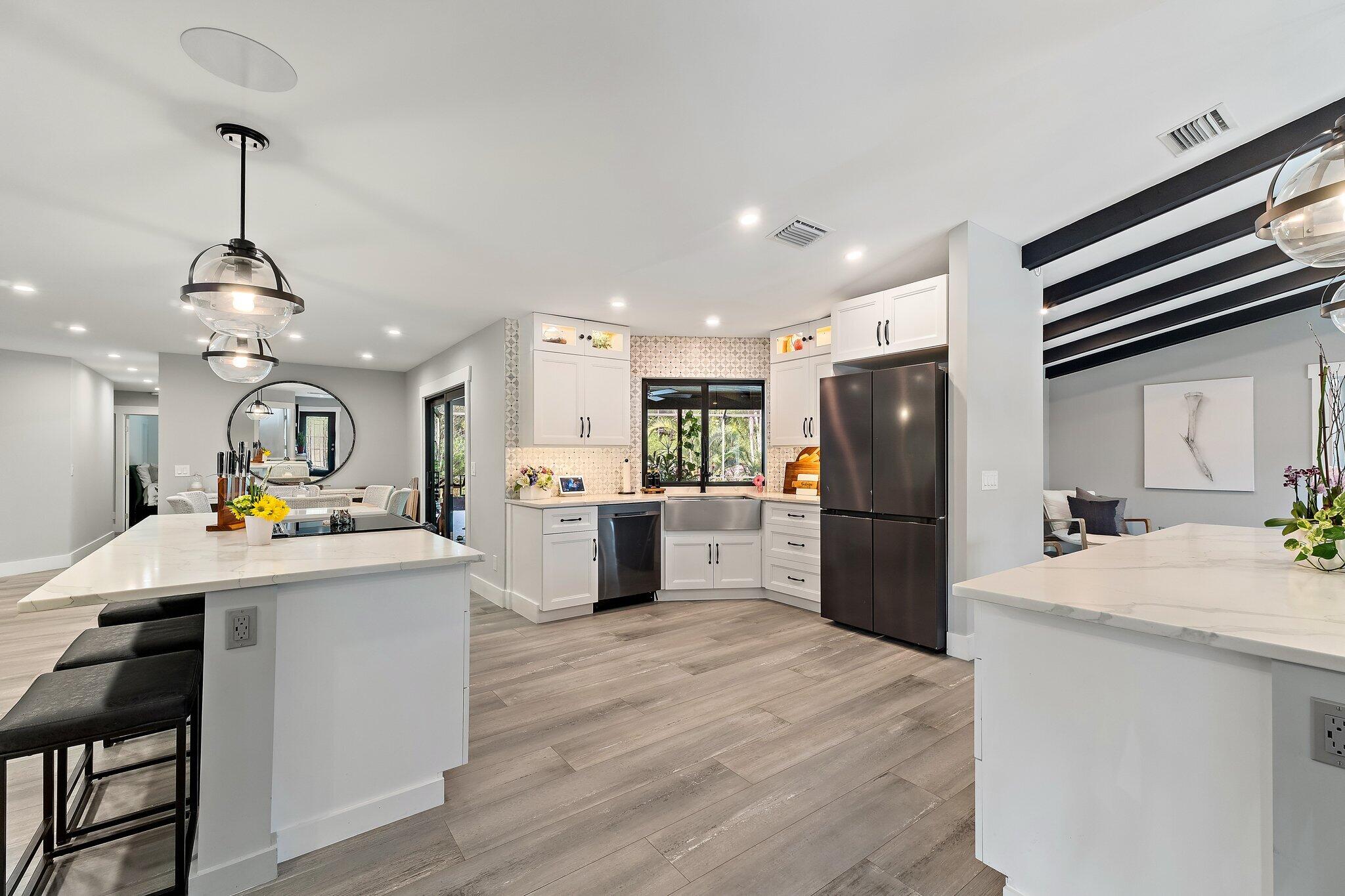 11845 165th Road North Jupiter, FL 33478 - Photo 32 of 68 a kitchen with refrigerator a sink and wooden floor