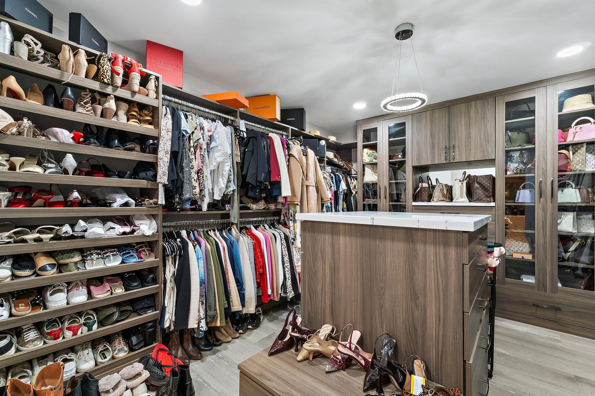 11845 165th Road North Jupiter, FL 33478 - Photo 34 of 68 a view of walk in closet with clothes and shoes