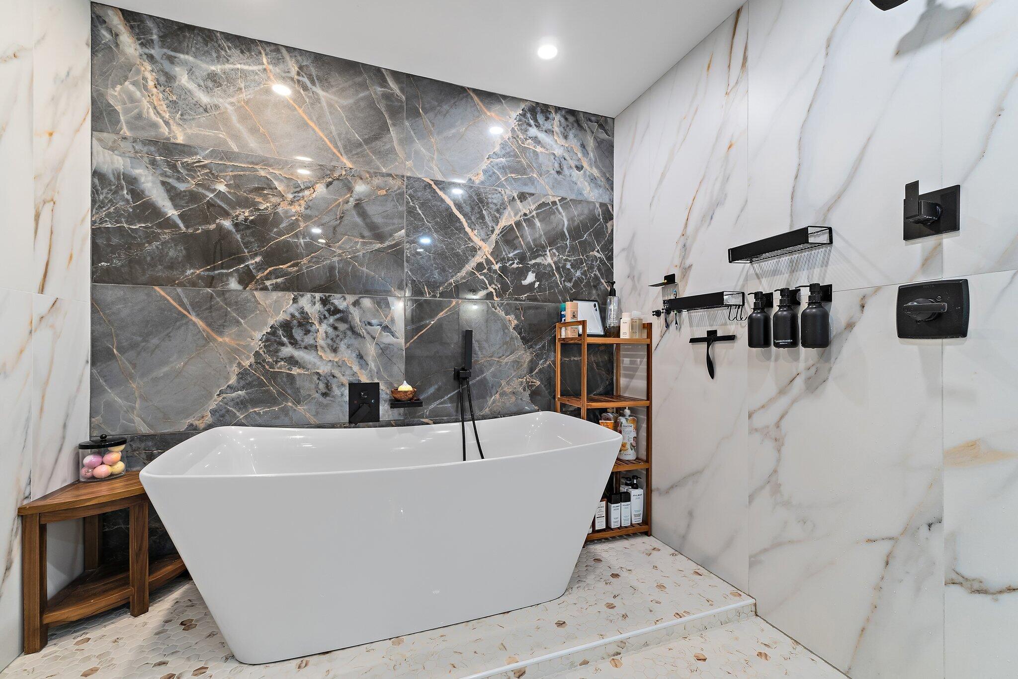 11845 165th Road North Jupiter, FL 33478 - Photo 36 of 68 a white bath tub sitting in a bathroom