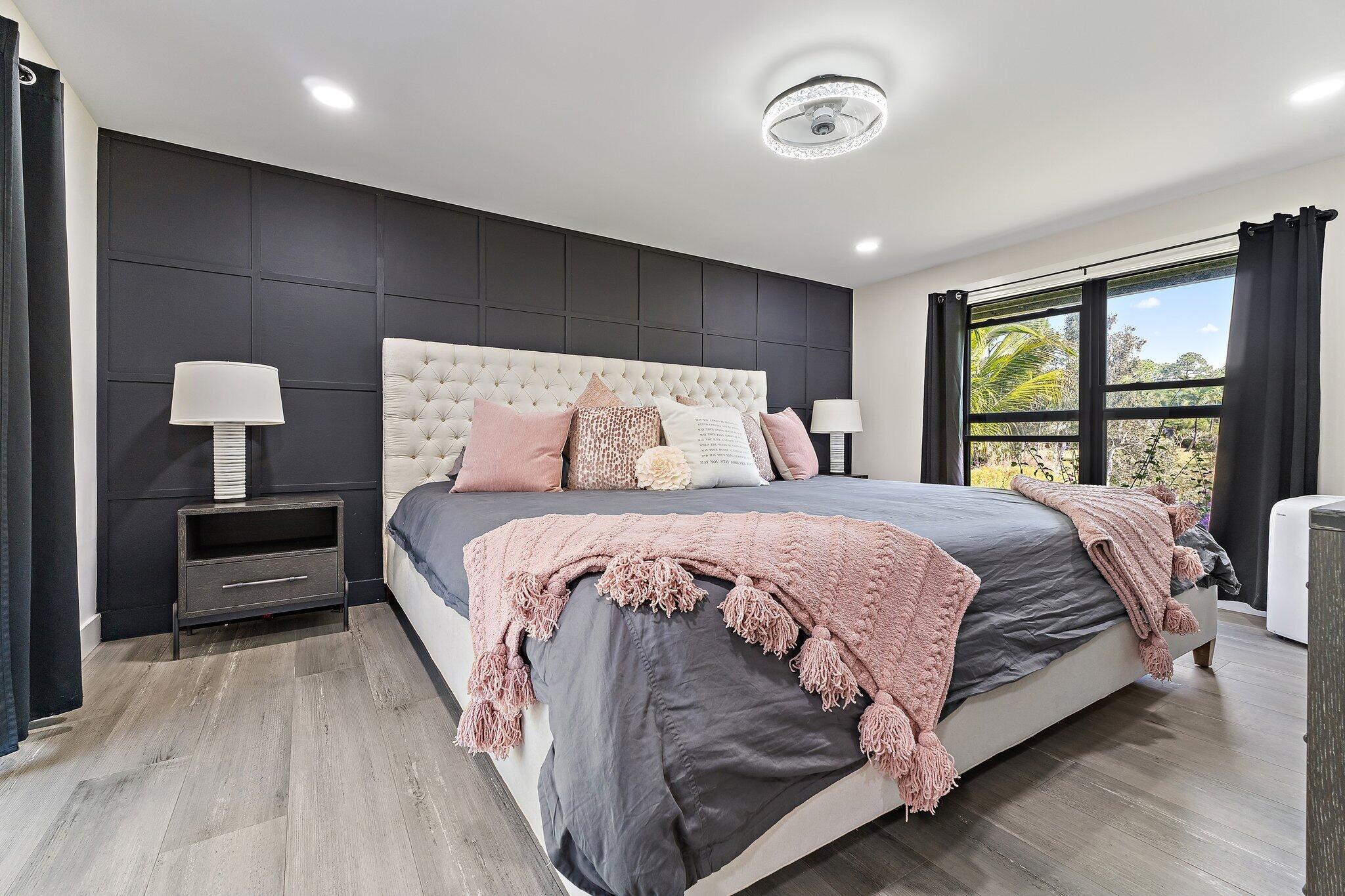 11845 165th Road North Jupiter, FL 33478 - Photo 38 of 68 a bedroom with a bed and a large window