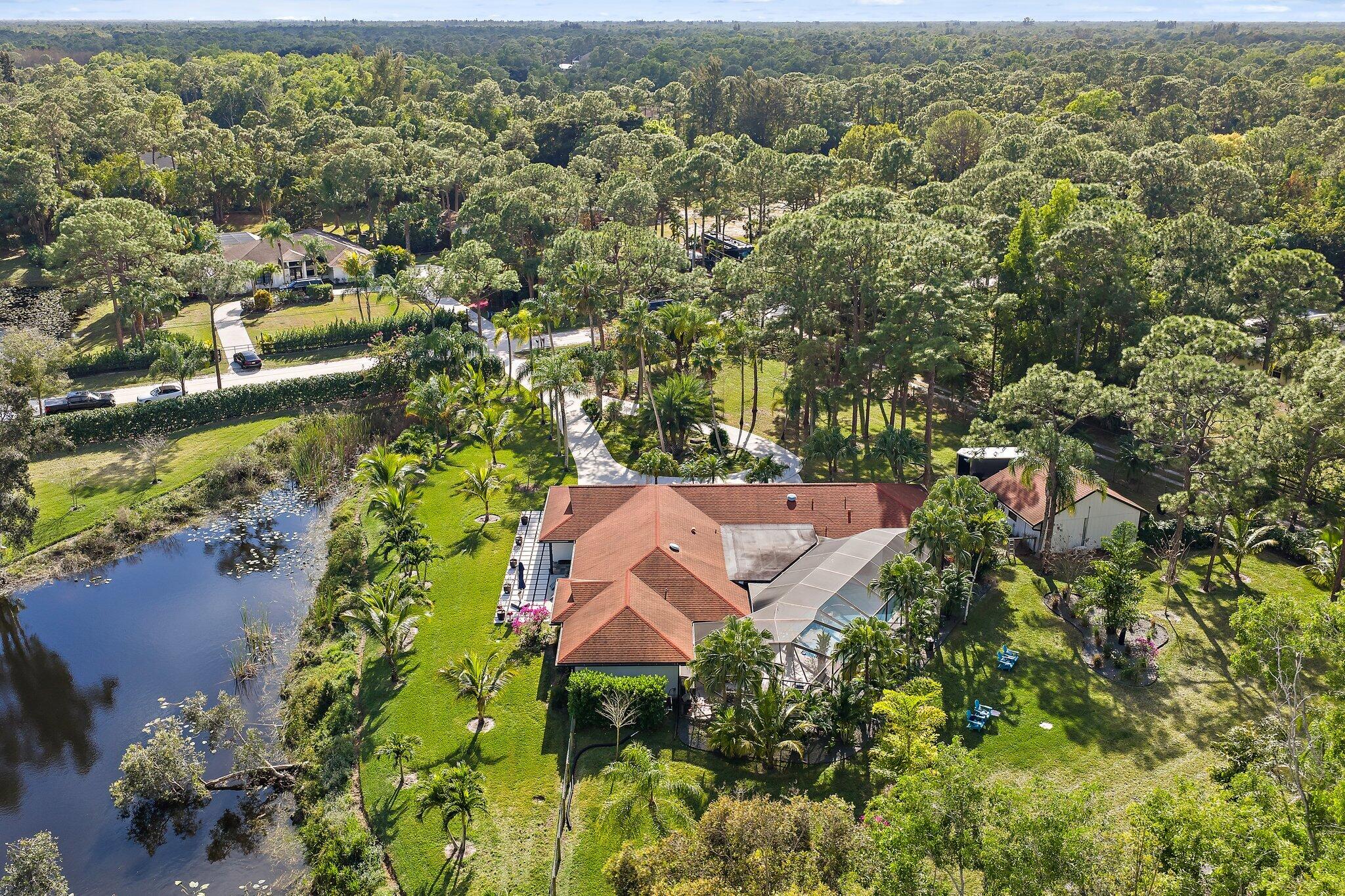 11845 165th Road North Jupiter, FL 33478 - Photo 4 of 68 an aerial view of residential house with outdoor space and trees all around