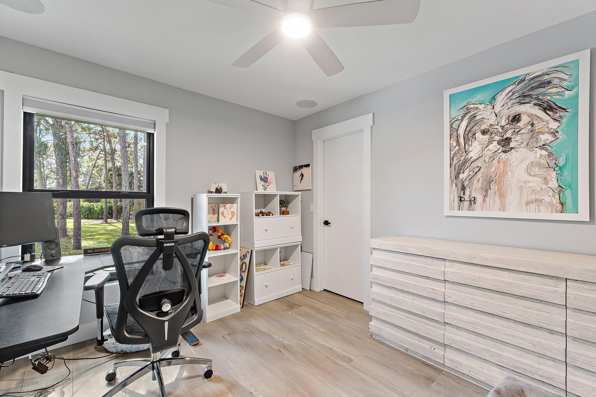 11845 165th Road North Jupiter, FL 33478 - Photo 44 of 68 a view of a workspace with furniture and a window