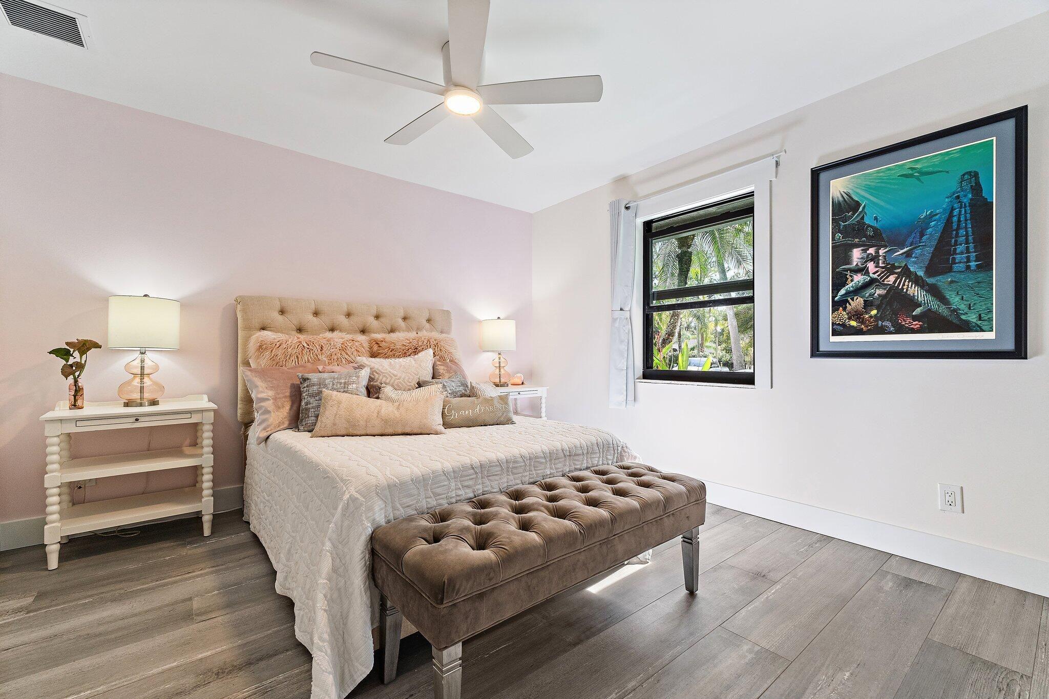 11845 165th Road North Jupiter, FL 33478 - Photo 50 of 68 a bedroom with a bed and a painting on the wall