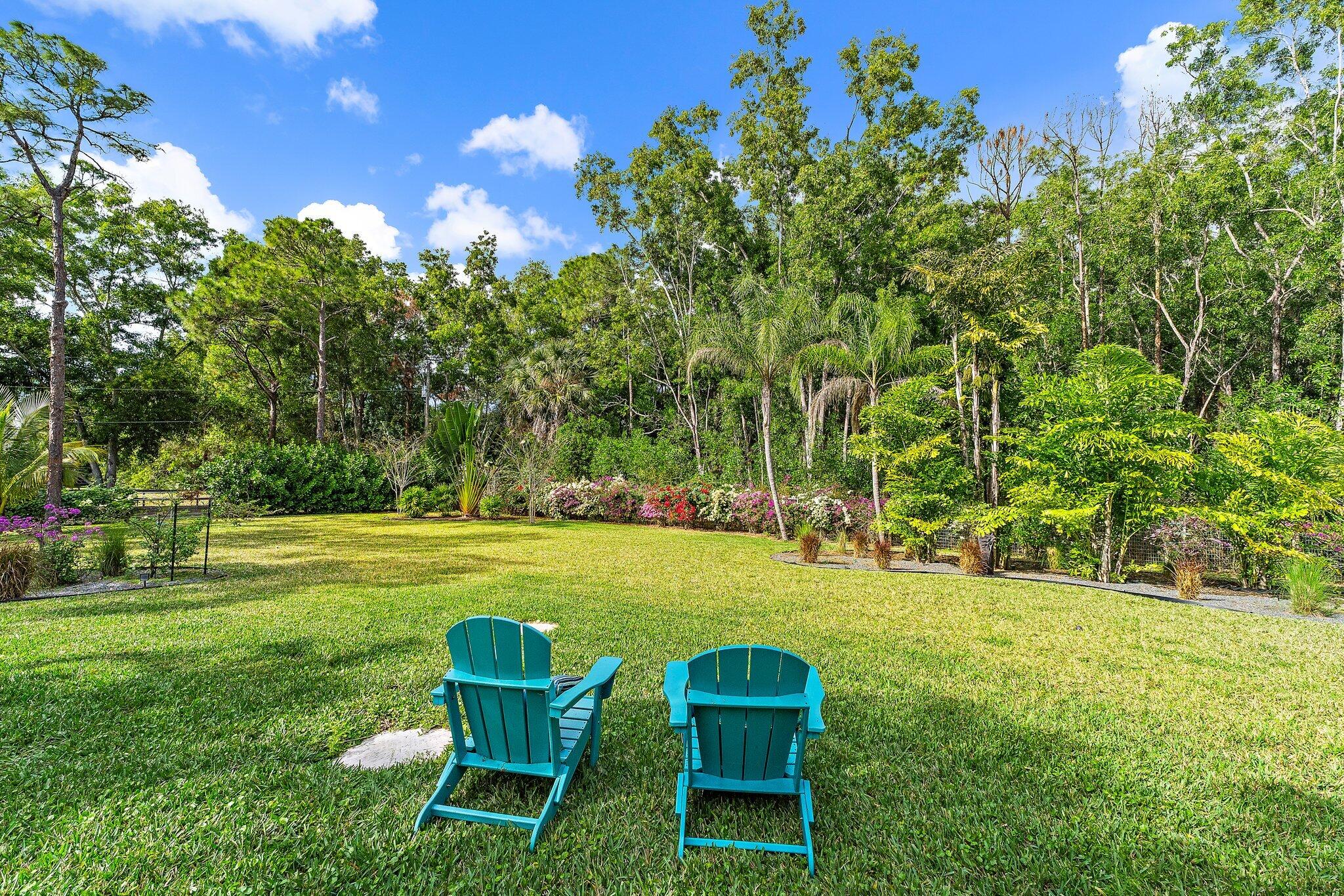 11845 165th Road North Jupiter, FL 33478 - Photo 61 of 68 a garden view with a seating space