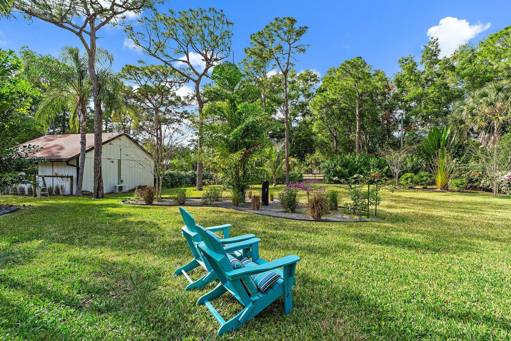 11845 165th Road North Jupiter, FL 33478 - Photo 62 of 68 a garden view with a seating space