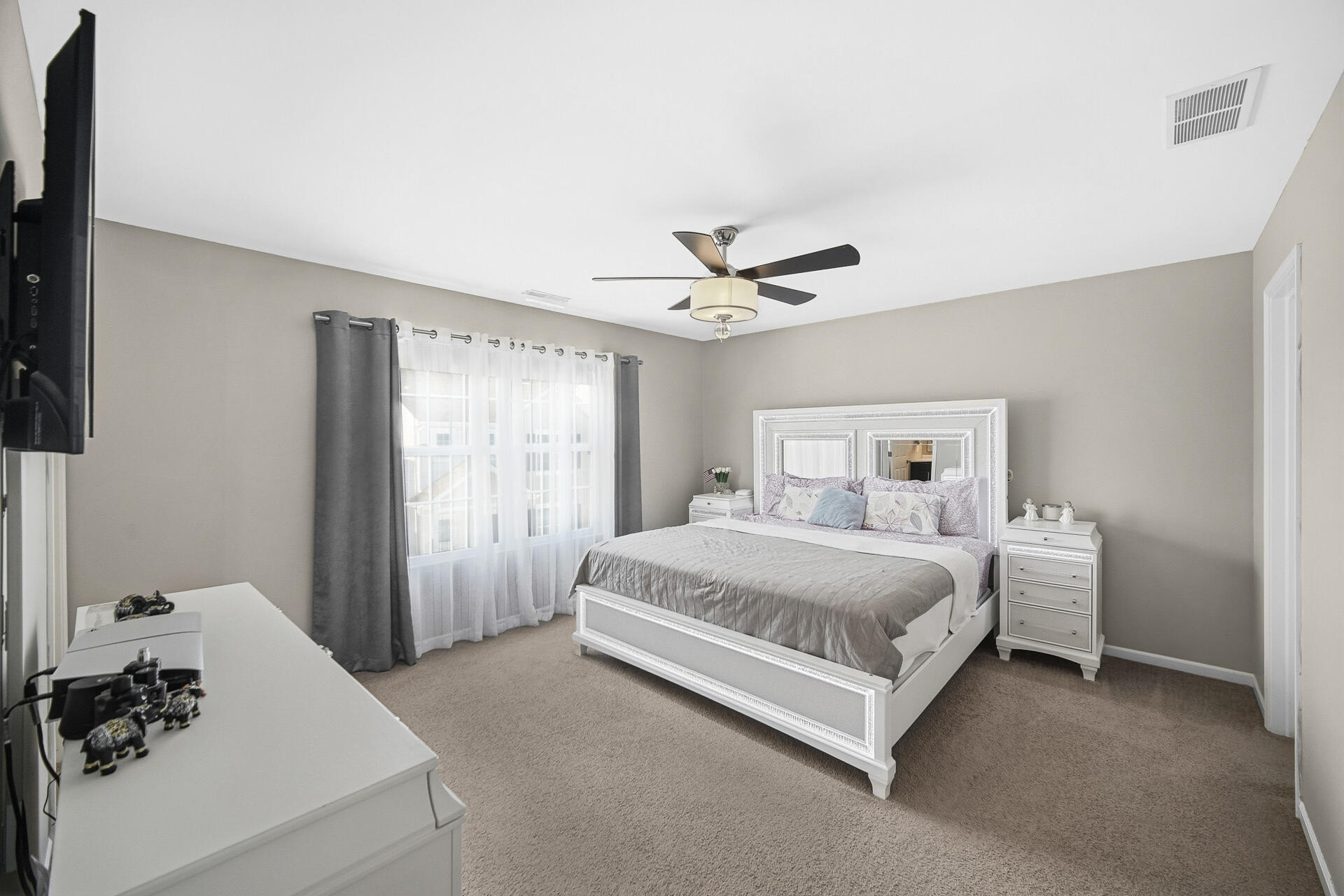 12728 Ellsworth Street Crown Point, IN 46307 - Photo 18 of 30 a spacious bedroom with a bed and a window