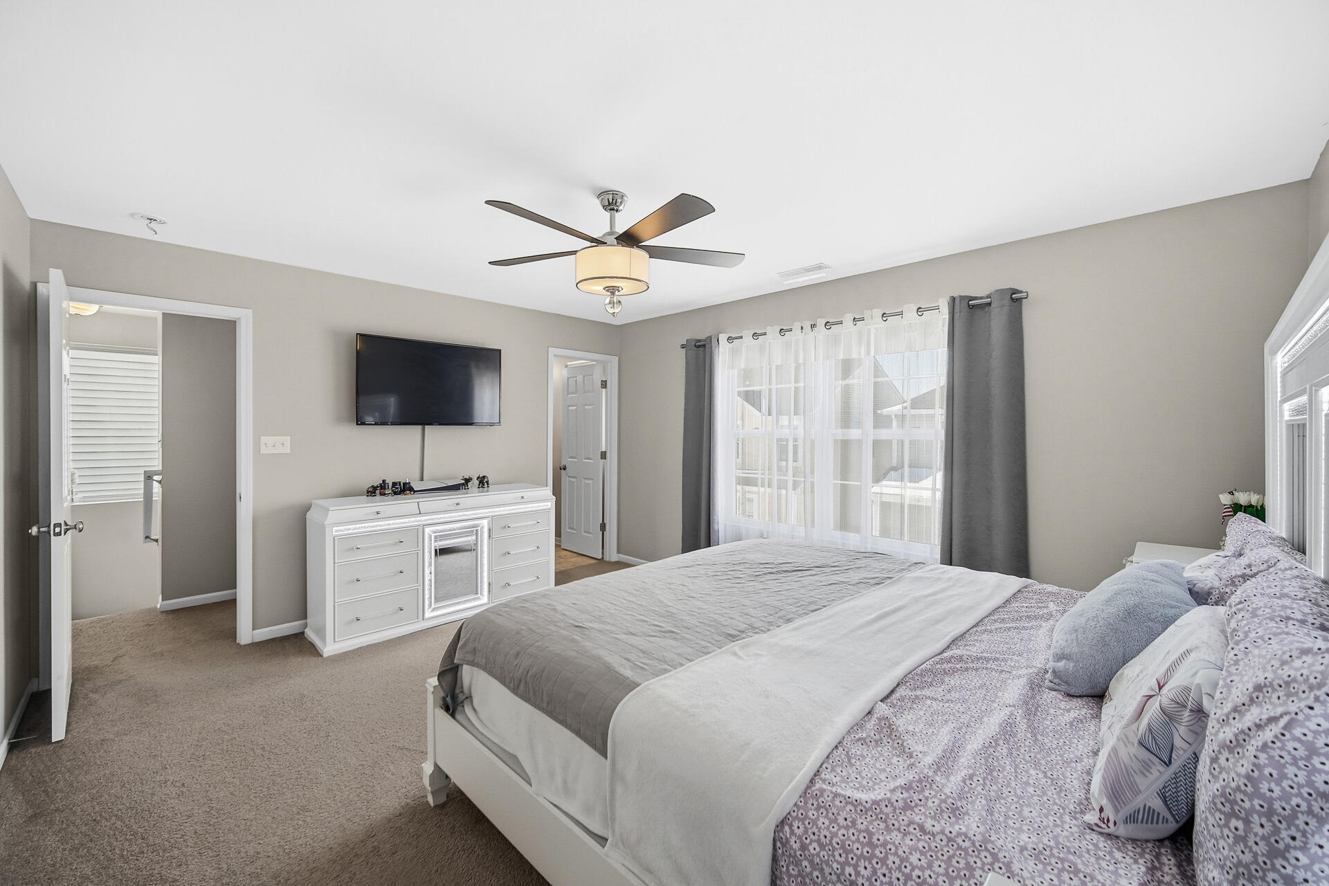 12728 Ellsworth Street Crown Point, IN 46307 - Photo 19 of 30 a bedroom with a bed and a flat screen tv