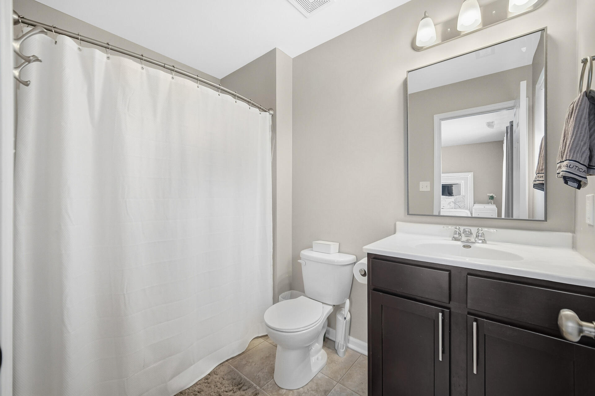 12728 Ellsworth Street Crown Point, IN 46307 - Photo 20 of 30 a bathroom with a sink a toilet and a mirror