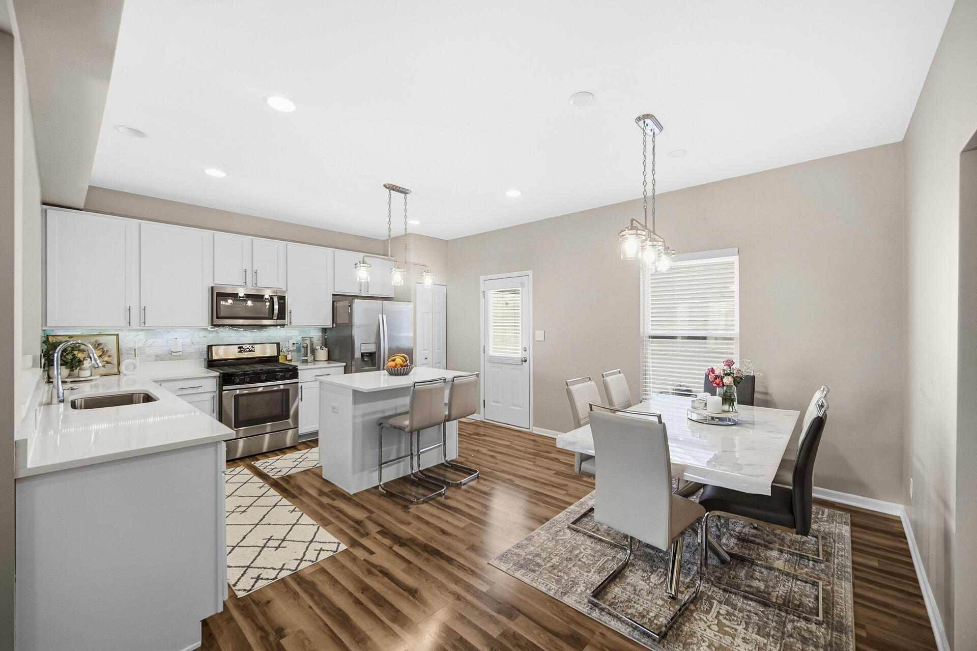 12728 Ellsworth Street Crown Point, IN 46307 - Photo 4 of 30 a kitchen with a dining table chairs and kitchen view