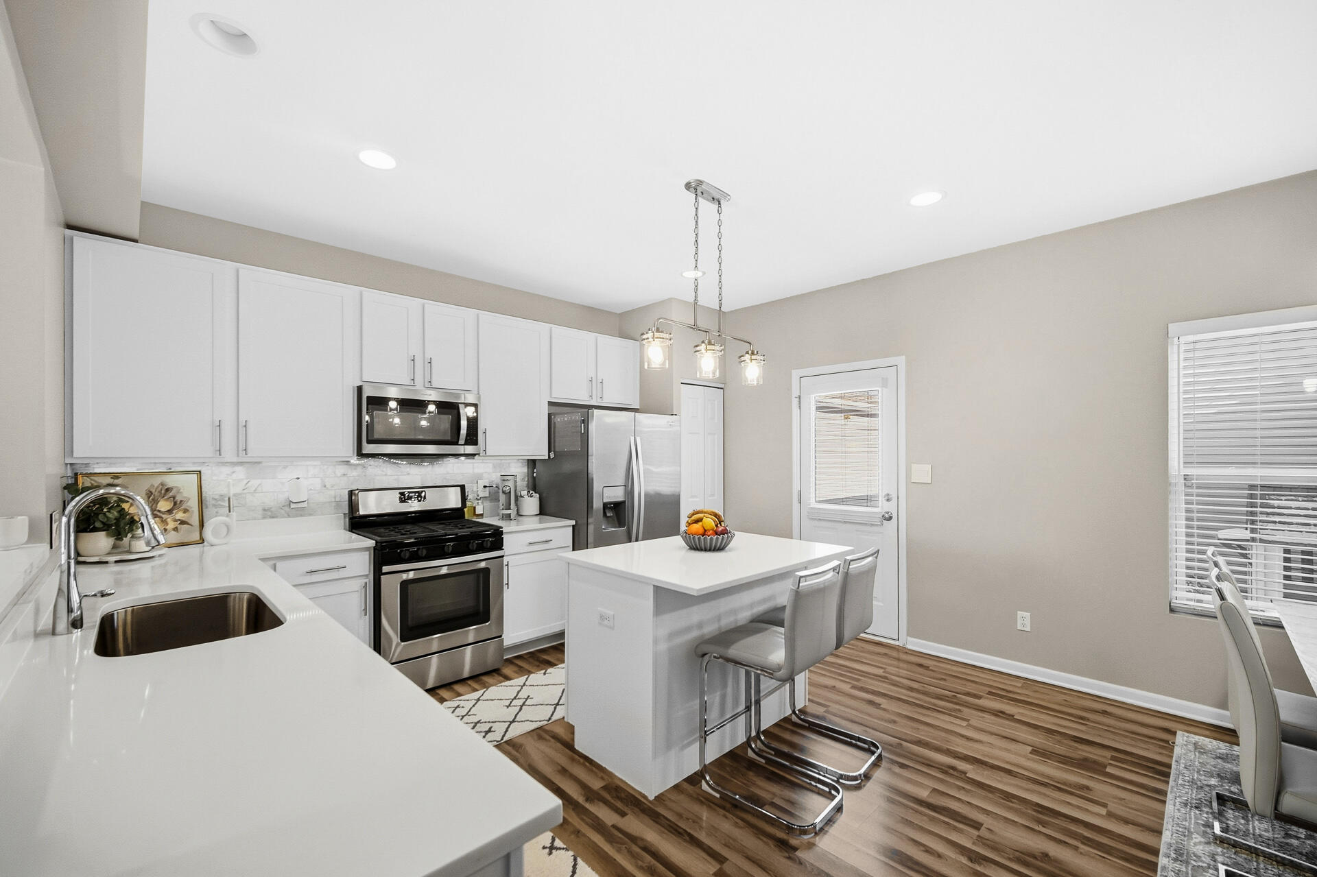 12728 Ellsworth Street Crown Point, IN 46307 - Photo 7 of 30 a kitchen with a stove a sink and a refrigerator