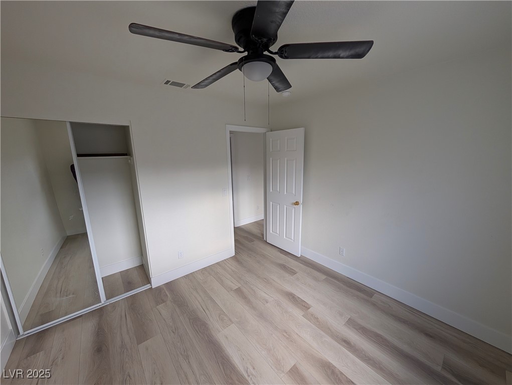 104 Appian Way Henderson, NV 89002 - Photo 14 of 52 Unfurnished bedroom featuring light wood finished floors, a closet, and ceiling fan