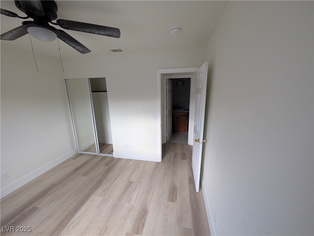 104 Appian Way Henderson, NV 89002 - Photo 15 of 52 Unfurnished bedroom with light wood-type flooring, a closet, and ceiling fan