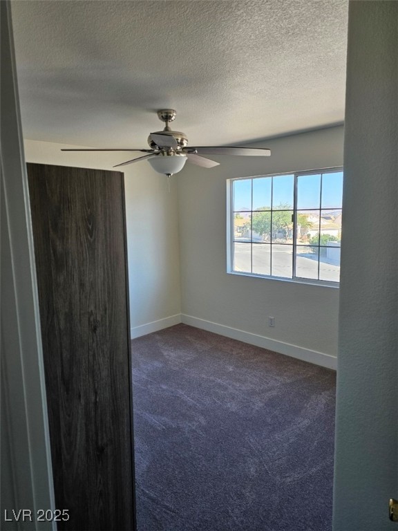 104 Appian Way Henderson, NV 89002 - Photo 35 of 52 Empty room featuring dark carpet and a textured ceiling