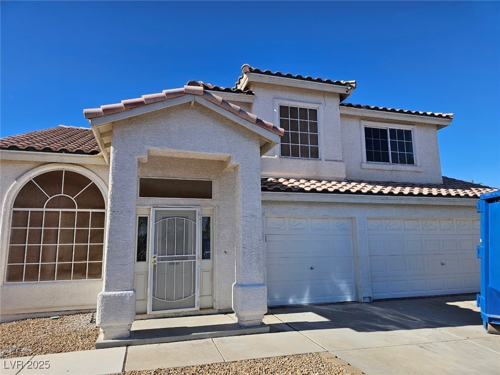 104 Appian Way Henderson, NV 89002 - Photo 48 of 52 Mediterranean / spanish home featuring a tiled roof, stucco siding, driveway, and a garage
