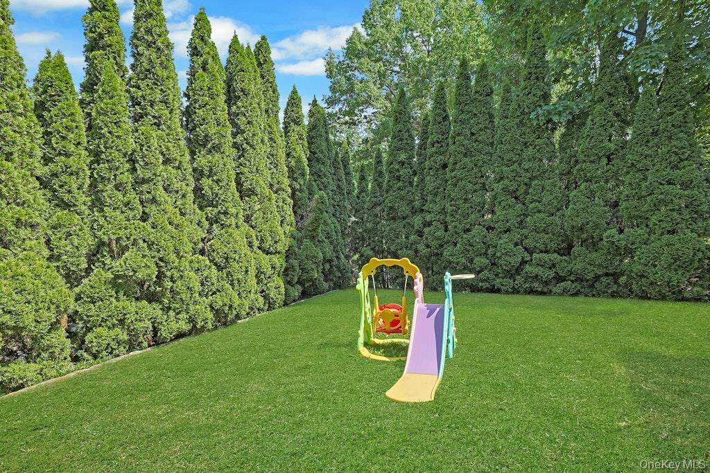 97 Underhill Road Scarsdale, NY 10583 - Photo 35 of 39 a view of a garden with a slide