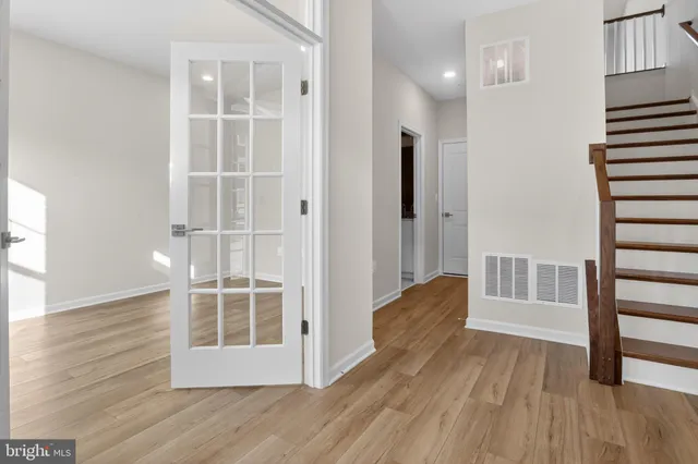a view of wooden floor and windows in a room