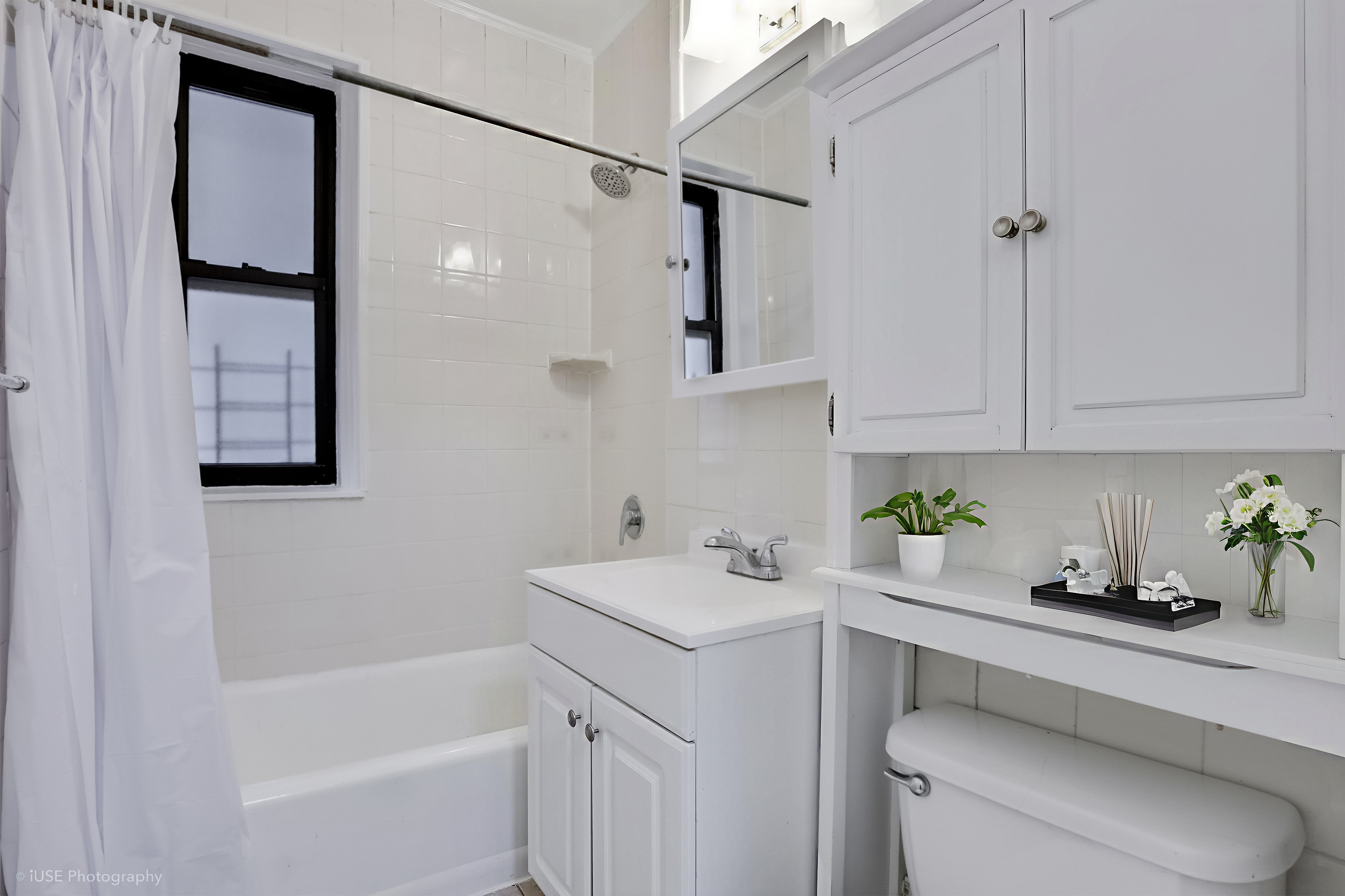1 West 126th Street, Unit 1C Manhattan, NY 10027 - Photo 10 of 11 a bathroom with a sink toilet vanity and tub