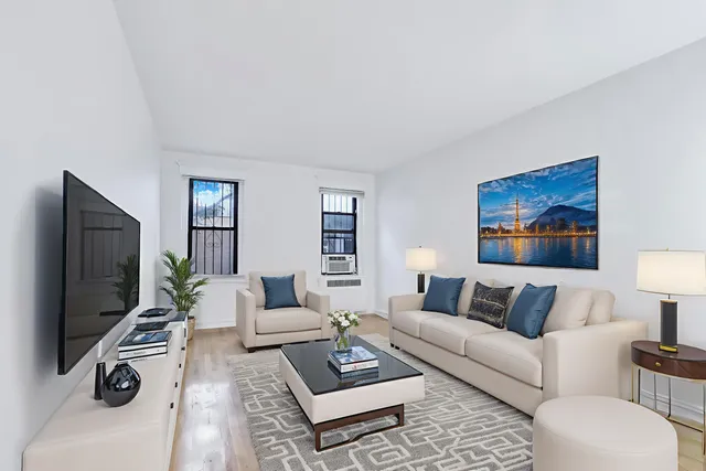 a living room with furniture a rug and a flat screen tv