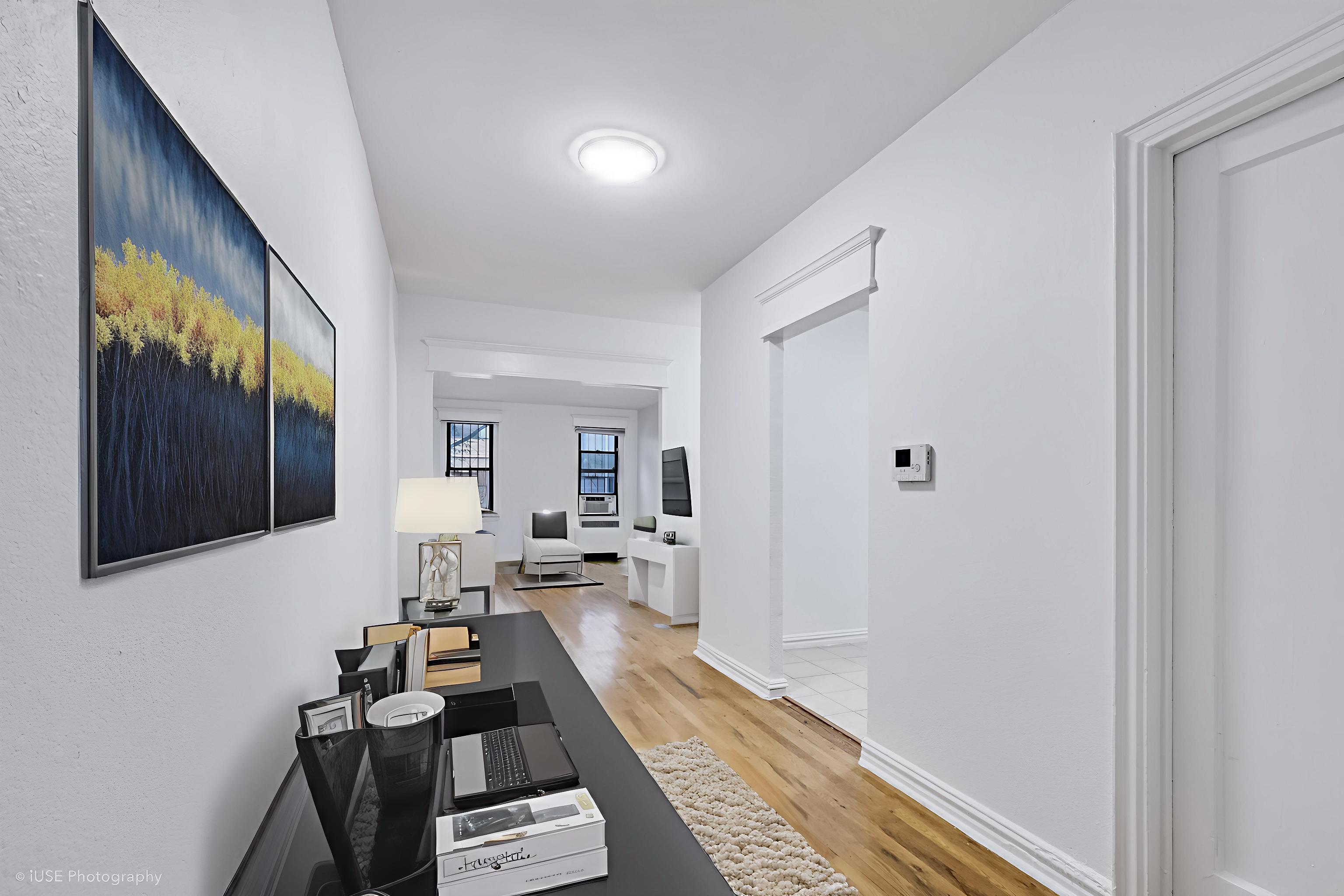 1 West 126th Street, Unit 1C Manhattan, NY 10027 - Photo 5 of 11 a living room with furniture and a rug