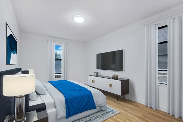 a bedroom with a bed and flat screen tv