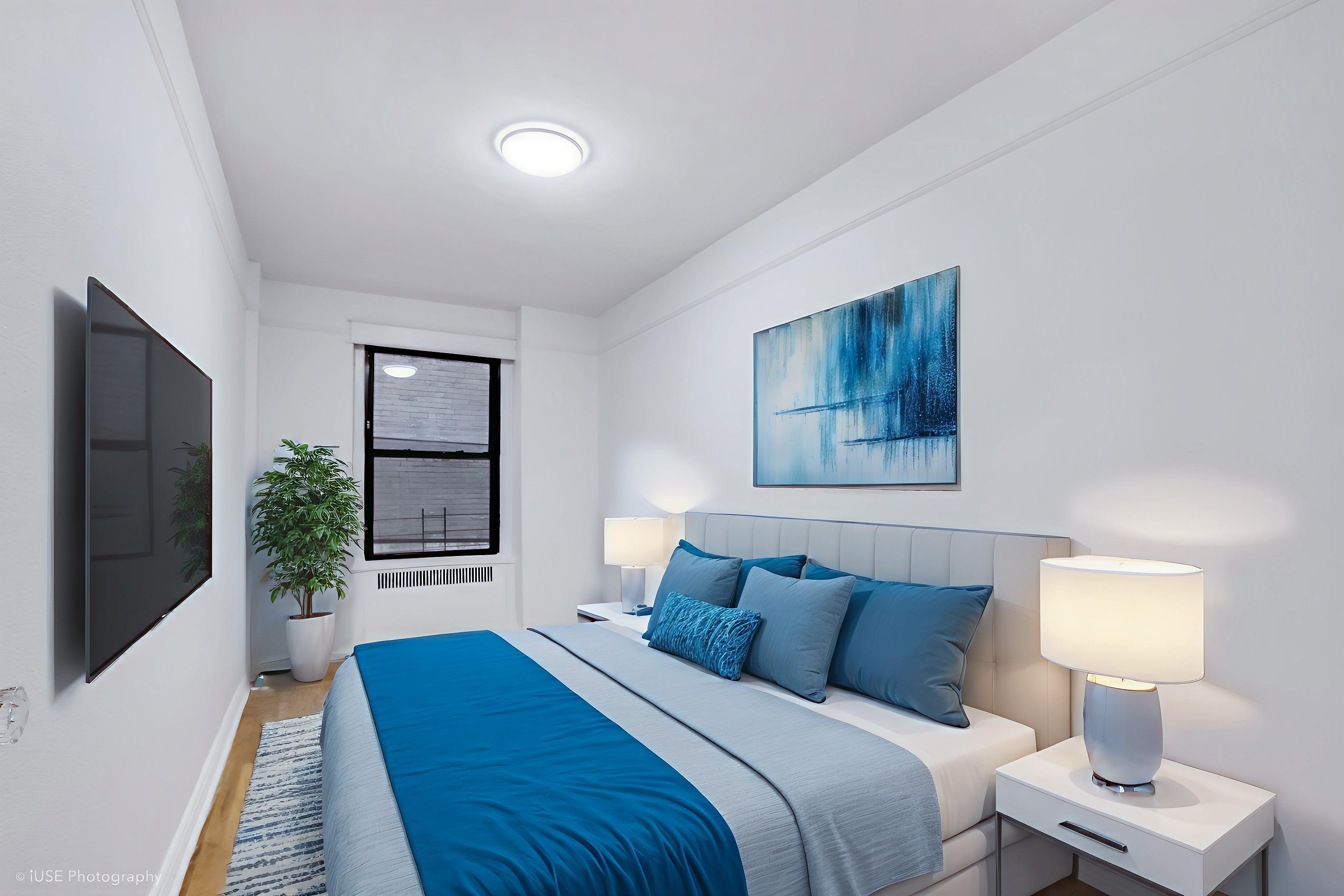 1 West 126th Street, Unit 1C Manhattan, NY 10027 - Photo 8 of 11 a bedroom with a bed and a large window