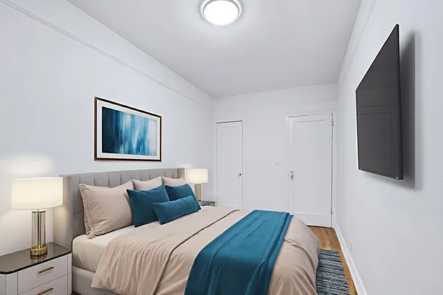 a bedroom with bed and a night stand