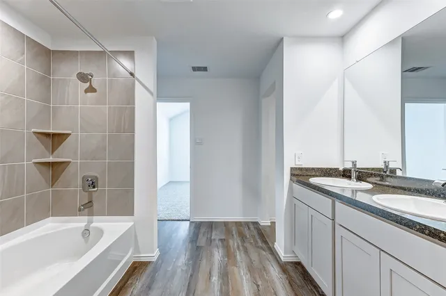 a bathroom with a bathtub and a sink