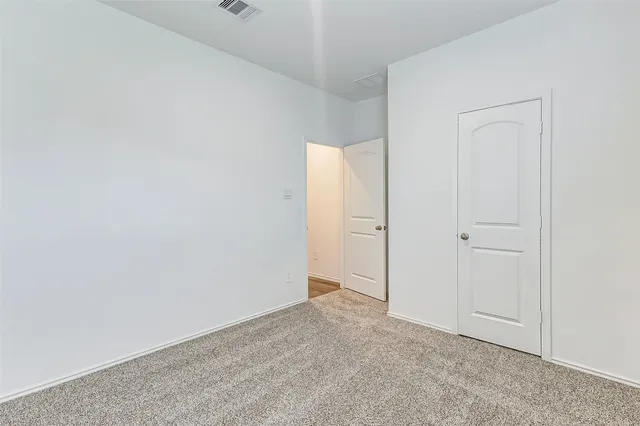 a view of an empty room and closet area
