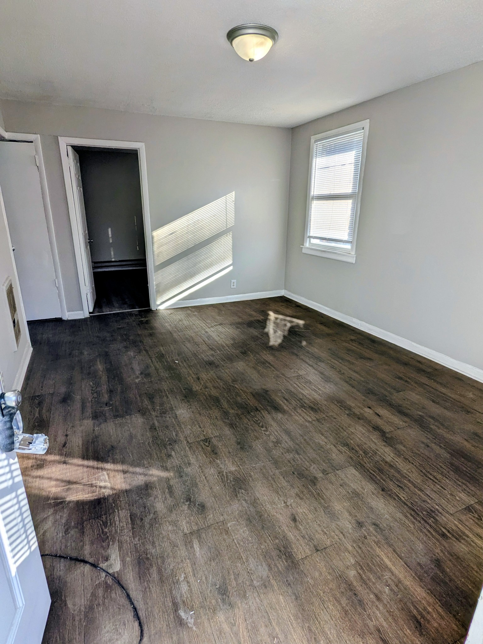 a view of a livingroom with wooden floor and window