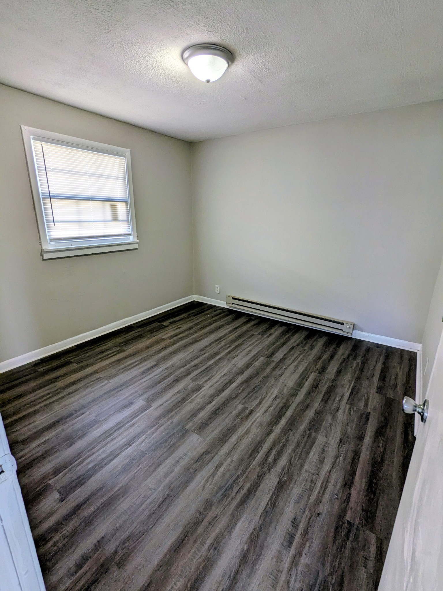 118 Rains Avenue, Unit 1 Nashville, TN 37203 - Photo 3 of 7 a view of an empty room and wooden floor