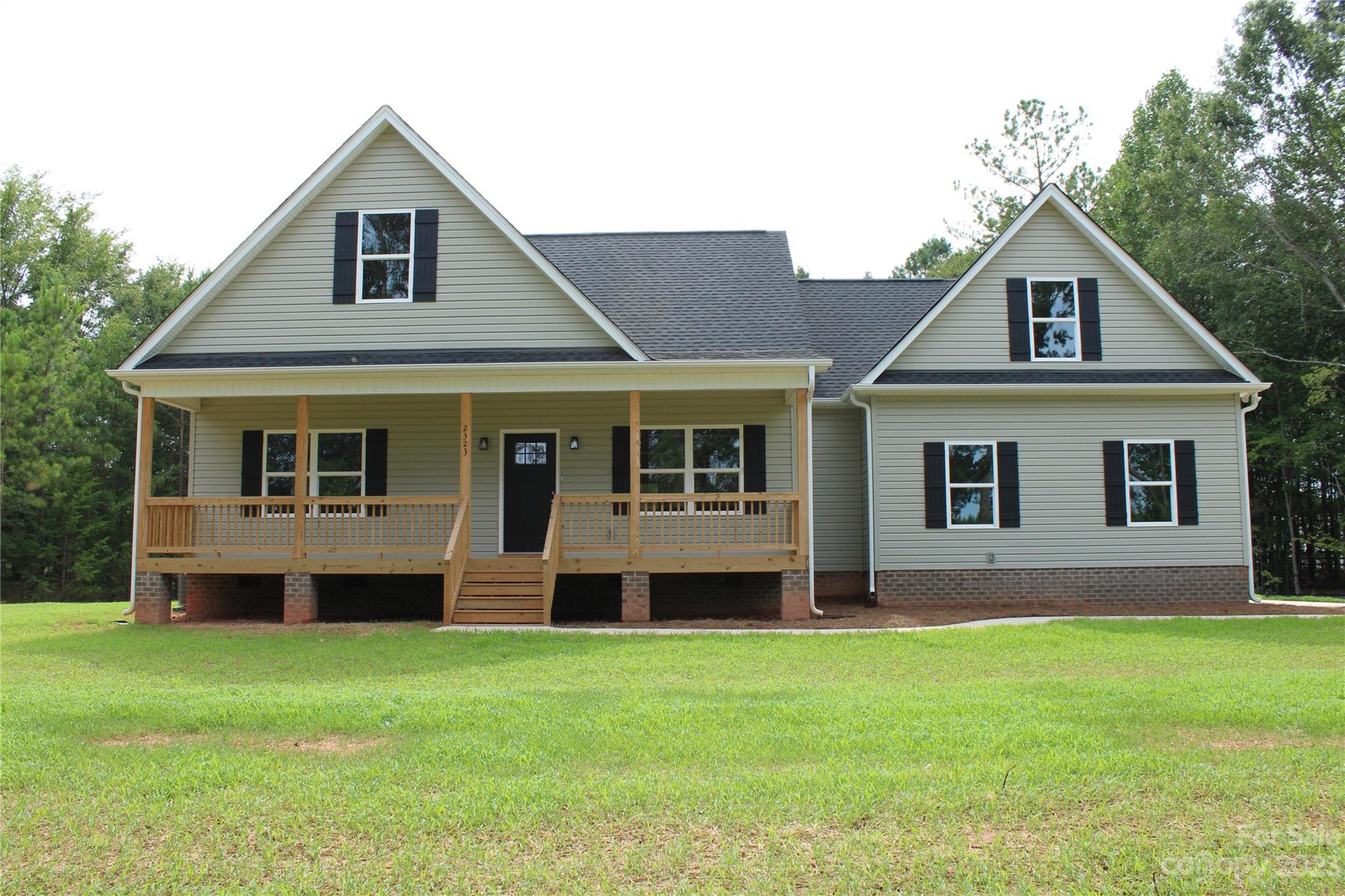 a front view of house with yard and green space
