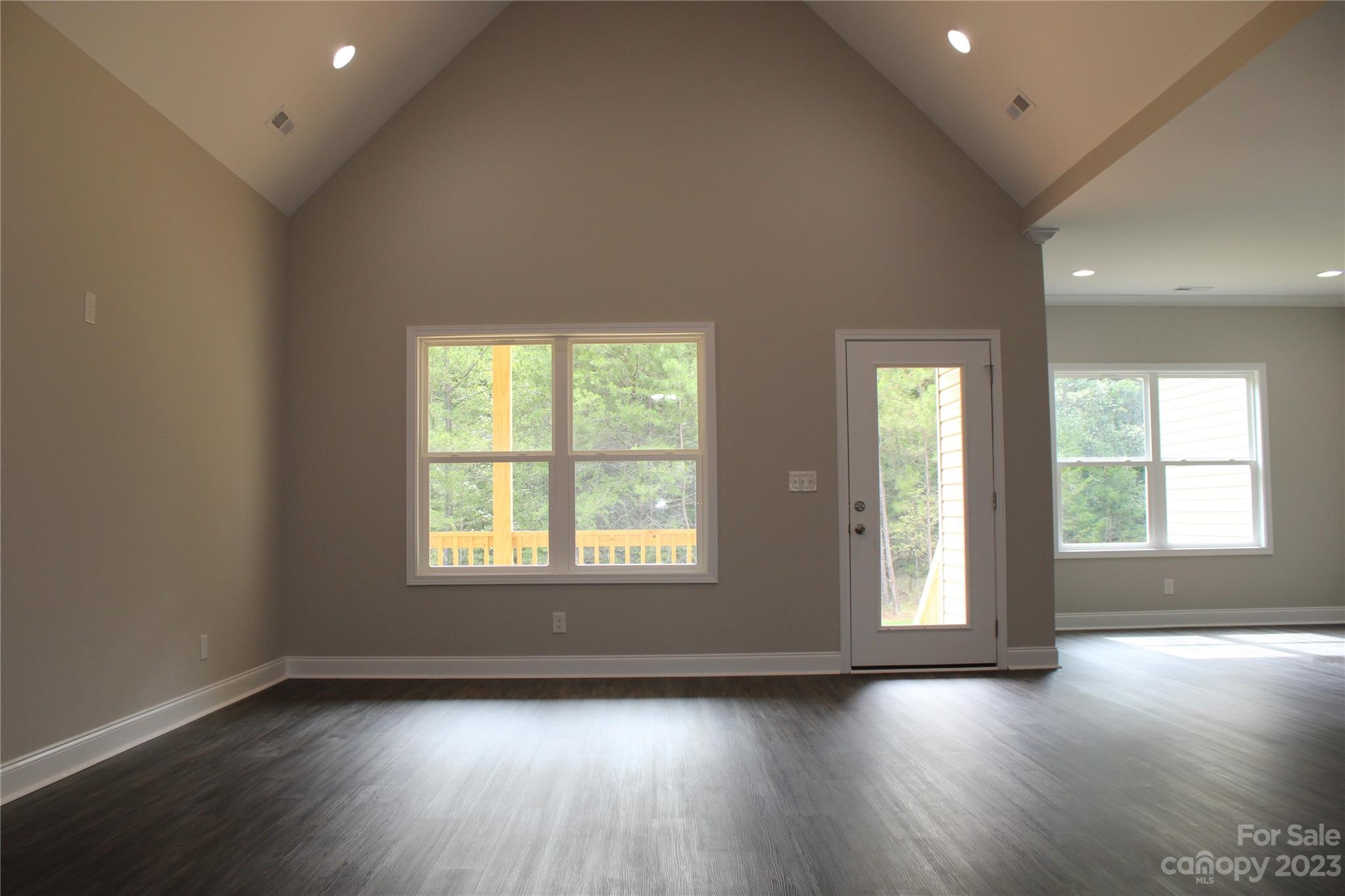 2323 State Rd S-46-172 Clover, SC 29710 - Photo 3 of 17 an empty room with wooden floor and windows