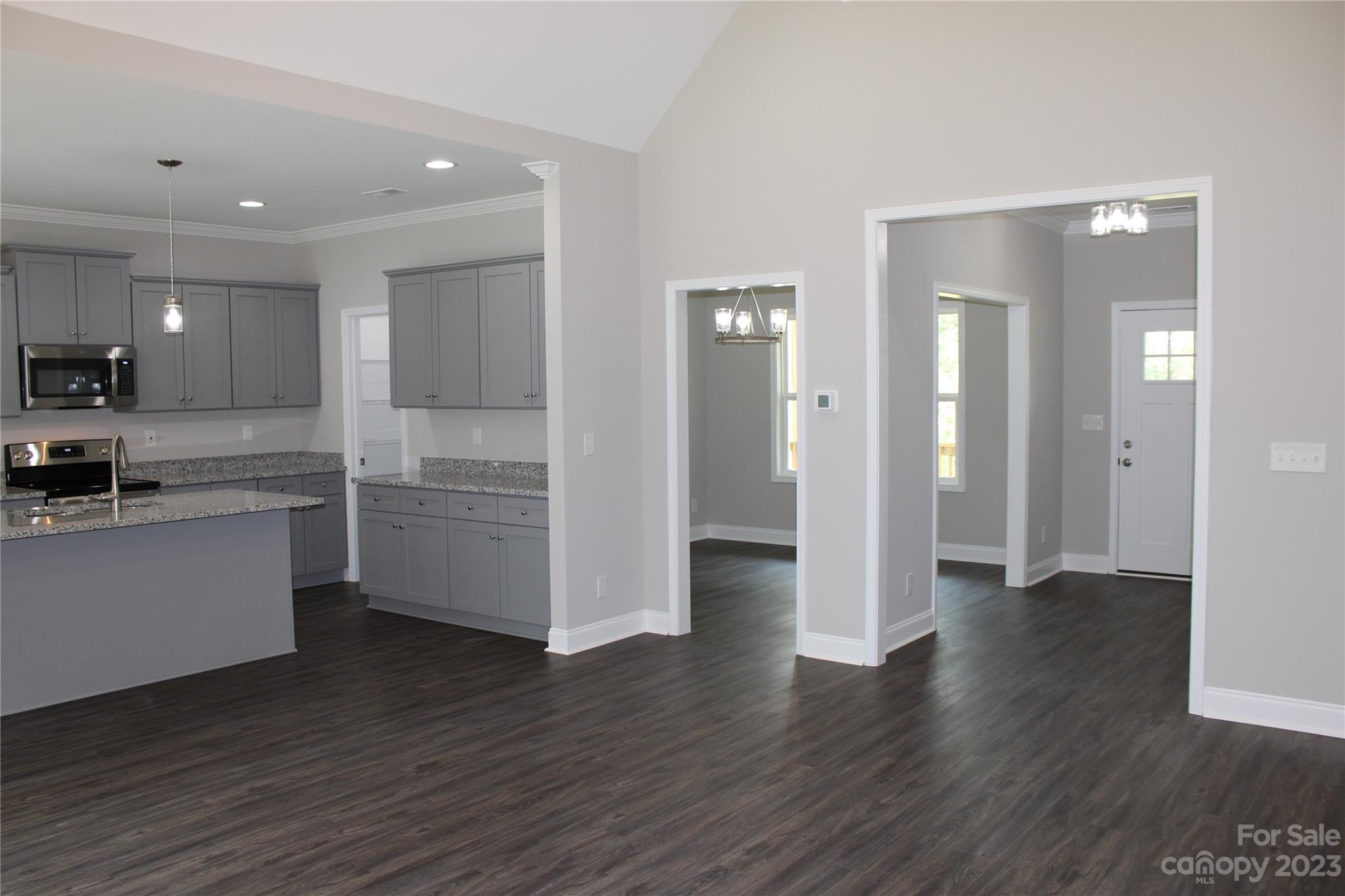 2323 State Rd S-46-172 Clover, SC 29710 - Photo 5 of 17 a view of a kitchen with wooden floor and electronic appliances