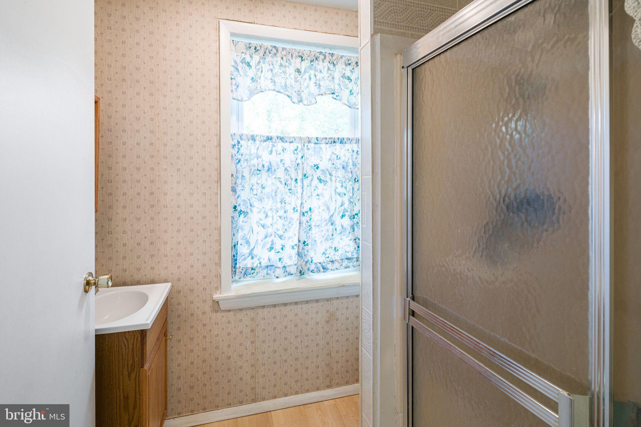 354 Ripka Street Philadelphia, PA 19128 - Photo 9 of 23 a bathroom with a shower and a window