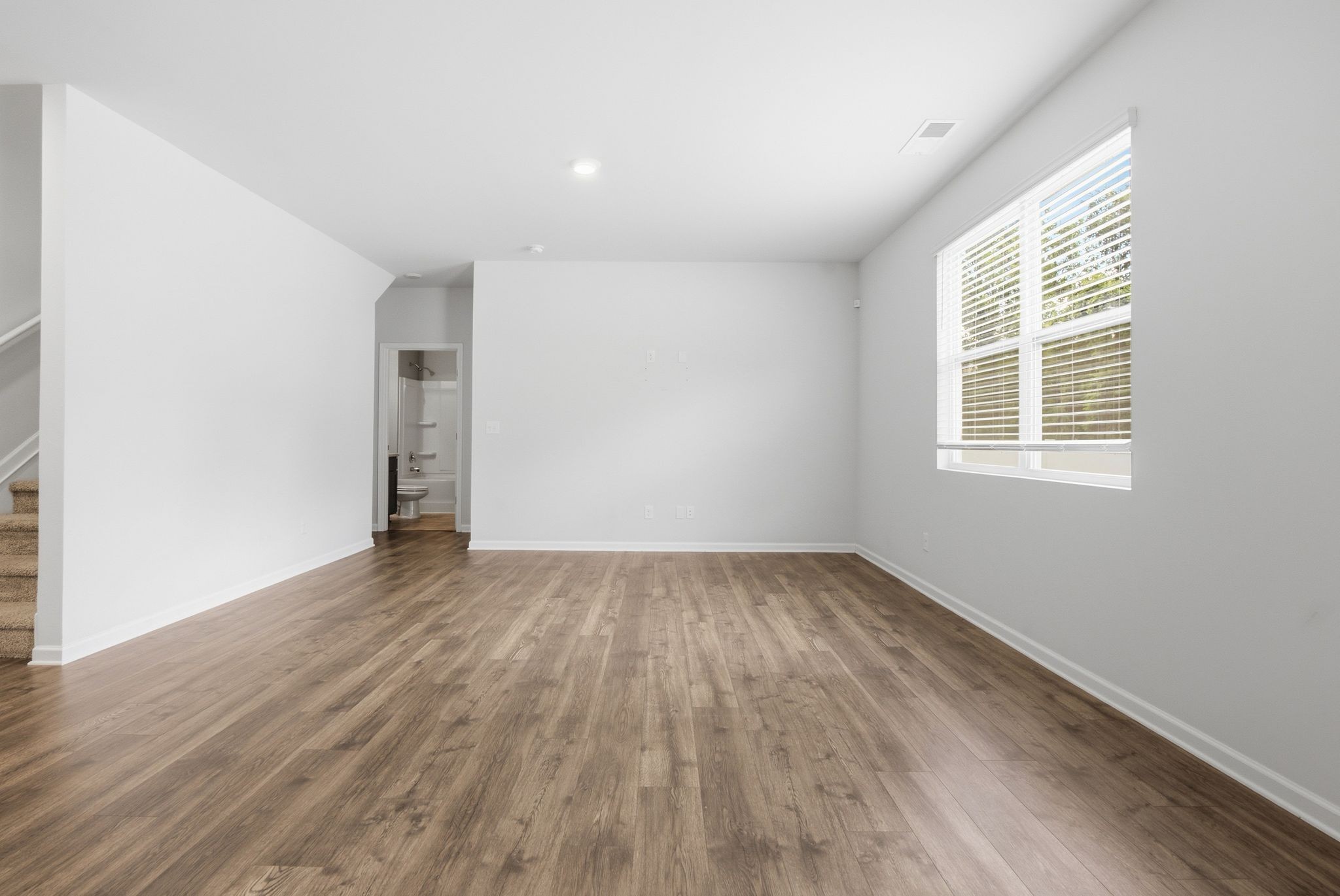 514 Ash Street Lebanon, TN 37087 - Photo 19 of 37 an empty room with wooden floor and windows