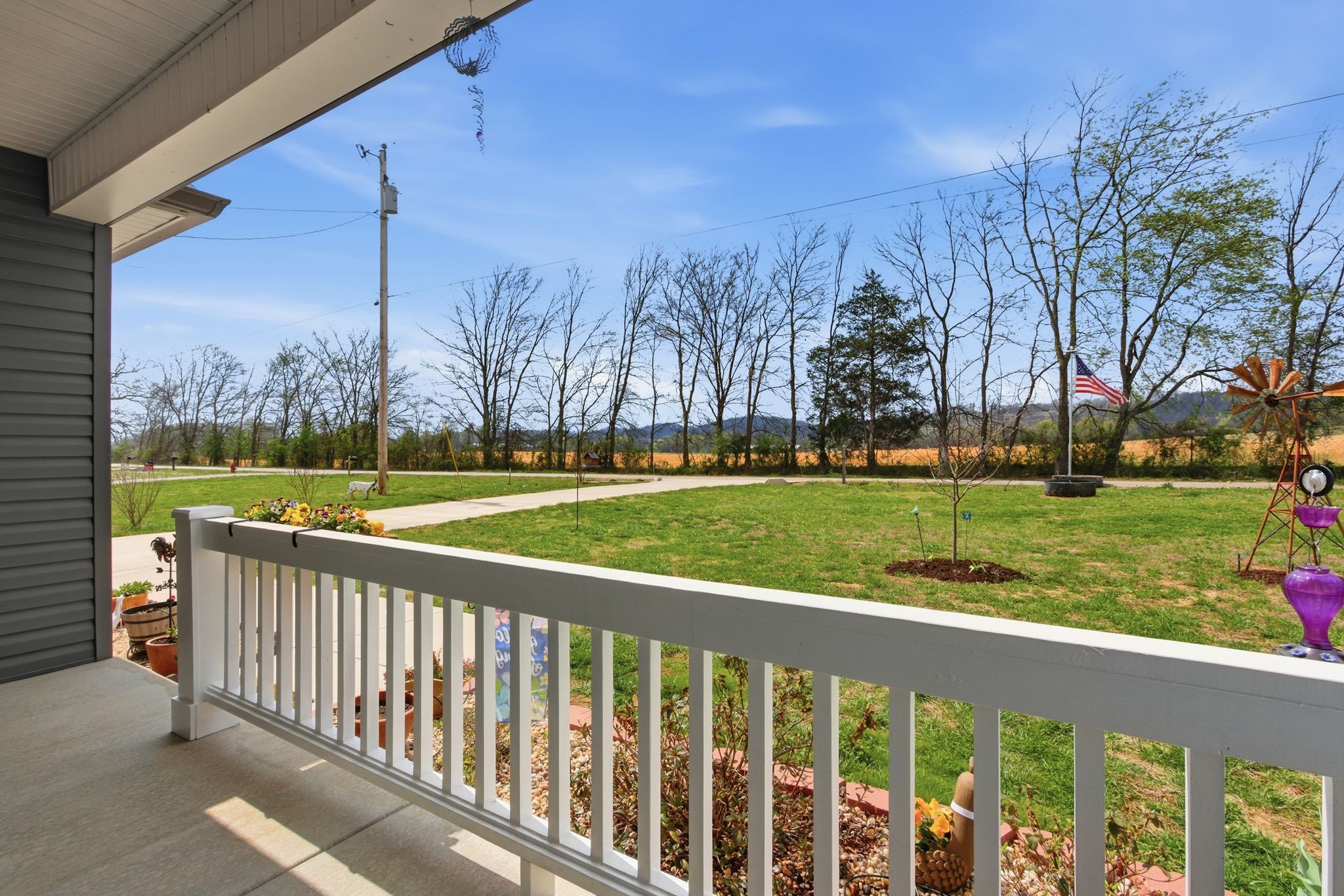 2705 Mc Connell Road Cornersville, TN 37047 - Photo 5 of 41 a view of a deck with a big yard and potted plants