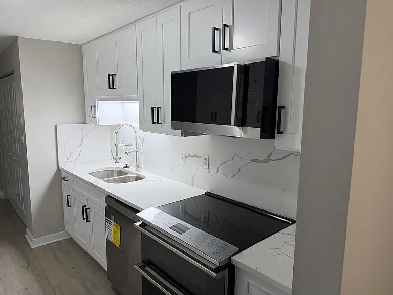 a kitchen with a sink and cabinets