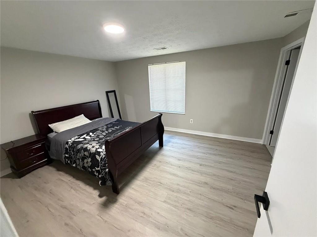 418 Engle Drive Tucker, GA 30084 - Photo 11 of 14 a bed sitting in a bedroom next to a window