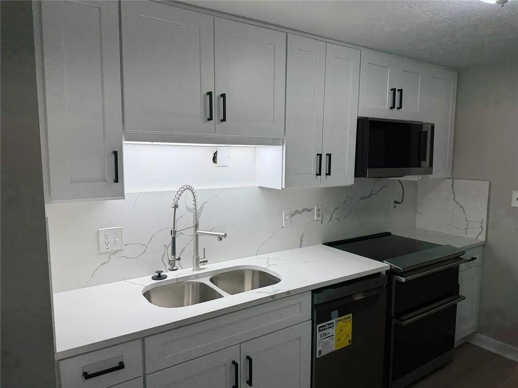 418 Engle Drive Tucker, GA 30084 - Photo 3 of 14 a kitchen with a sink and cabinets