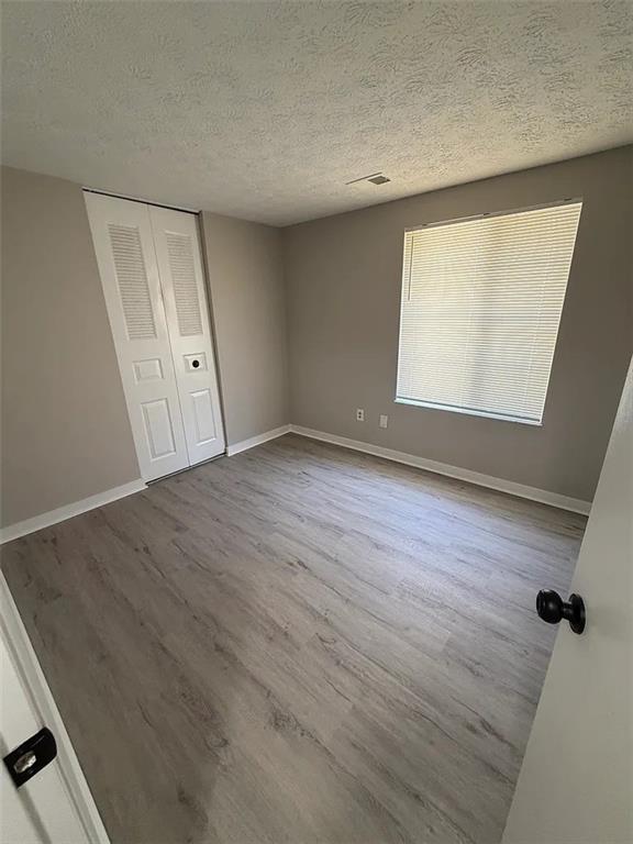 418 Engle Drive Tucker, GA 30084 - Photo 10 of 14 an empty room with wooden floor and windows
