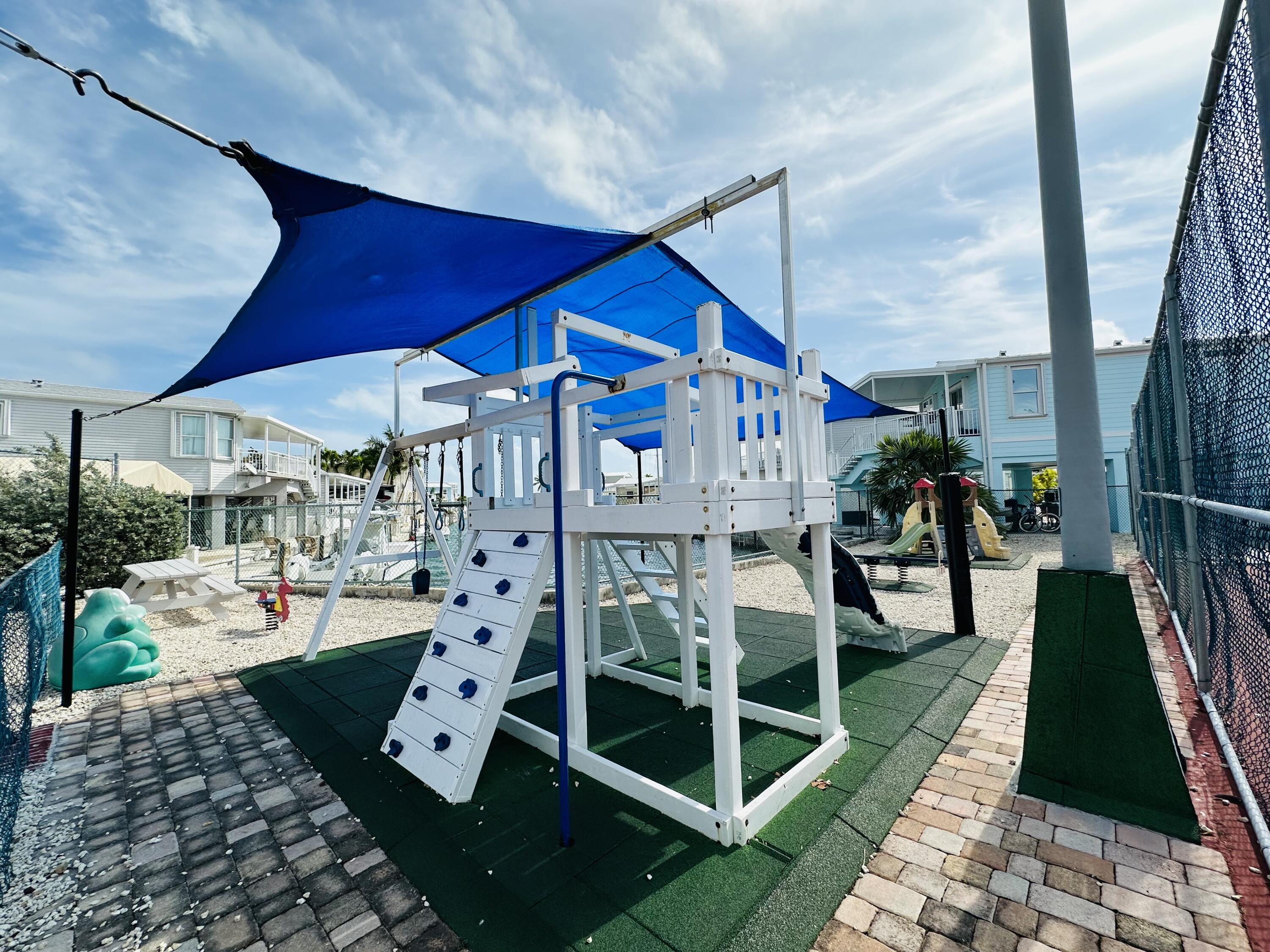 701 Spanish Main Drive, Unit 635 Cudjoe, FL 33042 - Photo 50 of 52 a view of a chairs and table in backyard