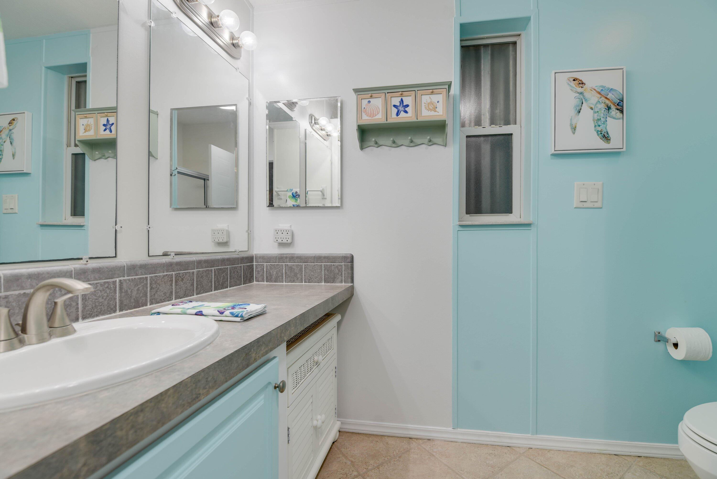 701 Spanish Main Drive, Unit 635 Cudjoe, FL 33042 - Photo 10 of 52 a bathroom with a granite countertop sink and a mirror