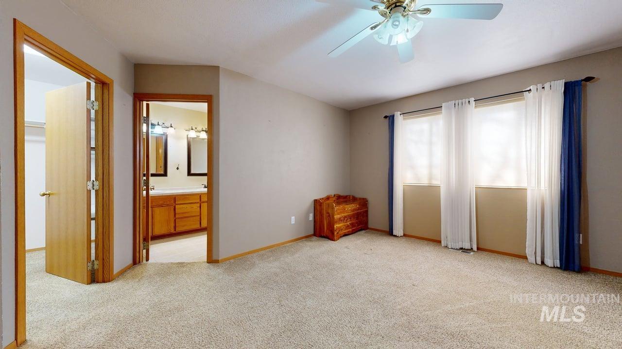 2794 9th Avenue Clarkston, WA 99403 - Photo 14 of 34 Unfurnished bedroom with light colored carpet, ceiling fan, and ensuite bath