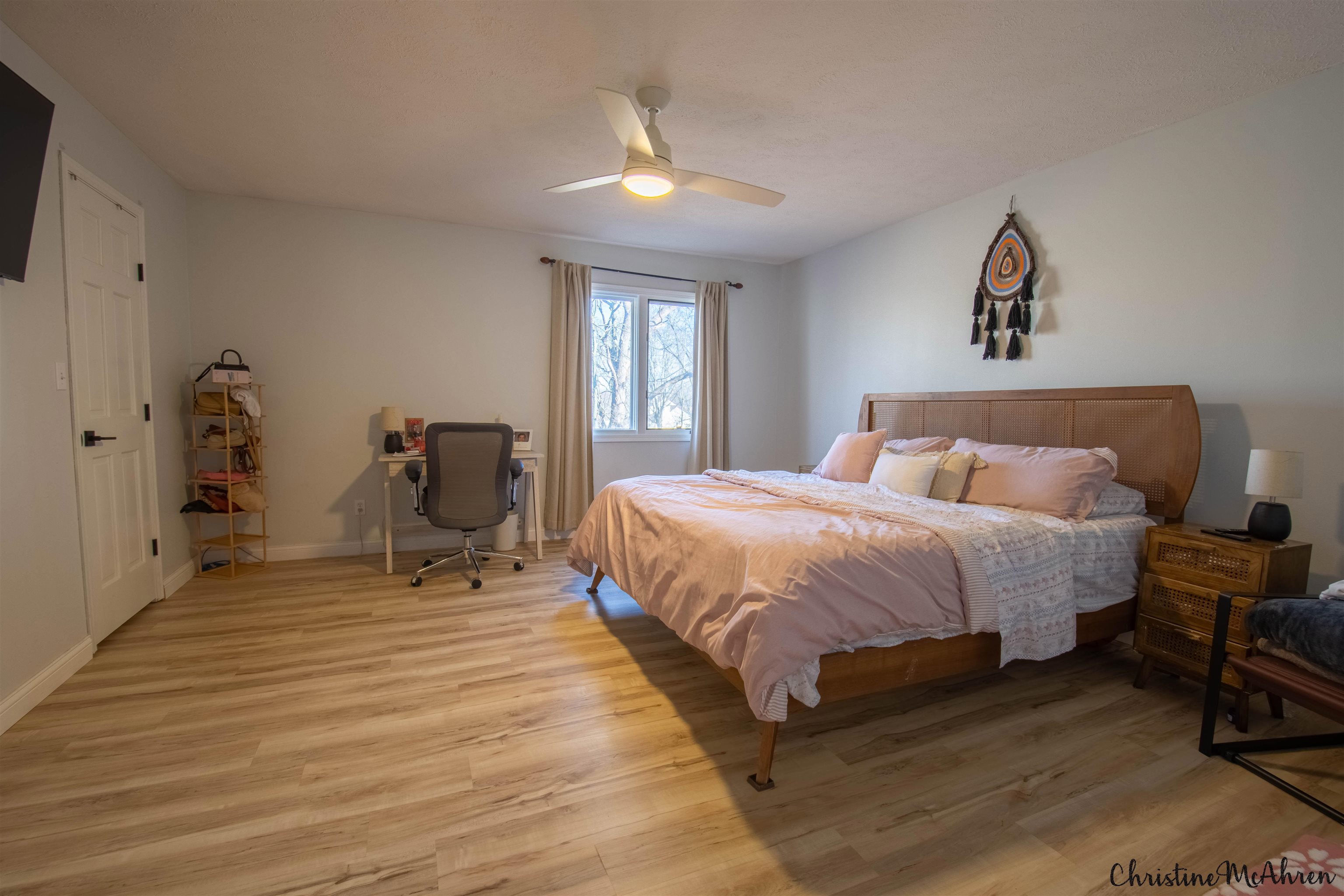 6410 Grassridge Road Rockford, IL 61108 - Photo 18 of 31 a spacious bedroom with a bed and a chandelier