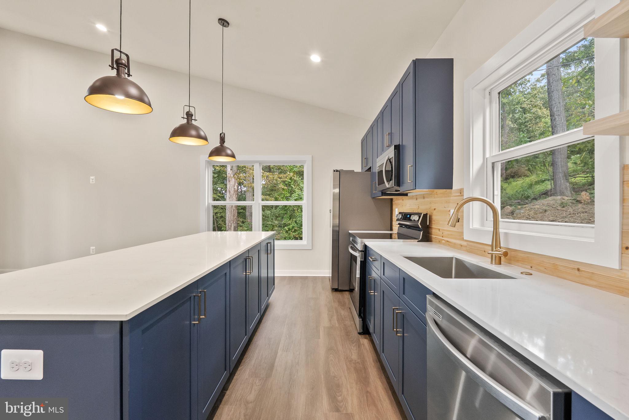 4769 Blue Mountain Road Linden, VA 22642 - Photo 8 of 36 a kitchen with kitchen island granite countertop a sink a counter space appliances and a window