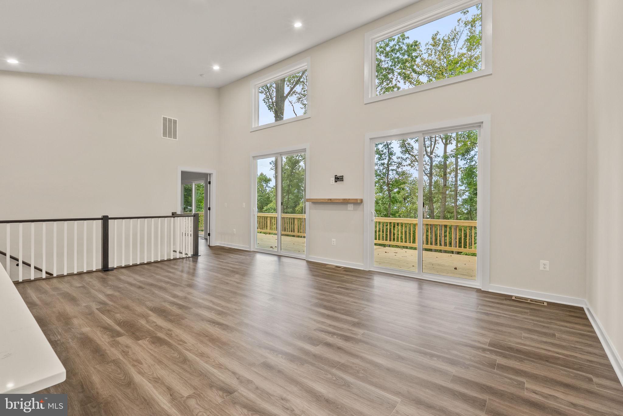 4769 Blue Mountain Road Linden, VA 22642 - Photo 9 of 36 a view of an empty room with wooden floor and a window
