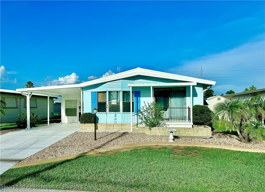 a front view of a house with a yard and porch