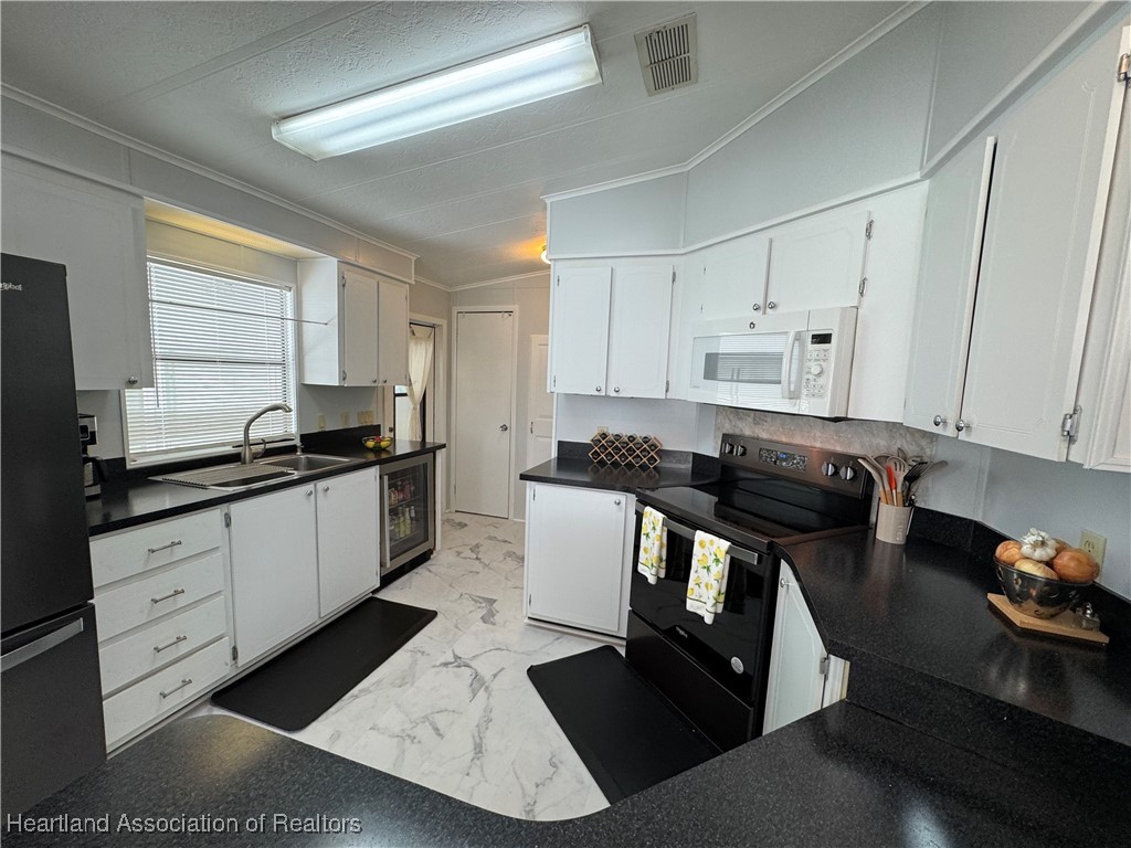 2940 Louis Street Sebring, FL 33872 - Photo 2 of 47 a kitchen with a sink appliances and cabinets